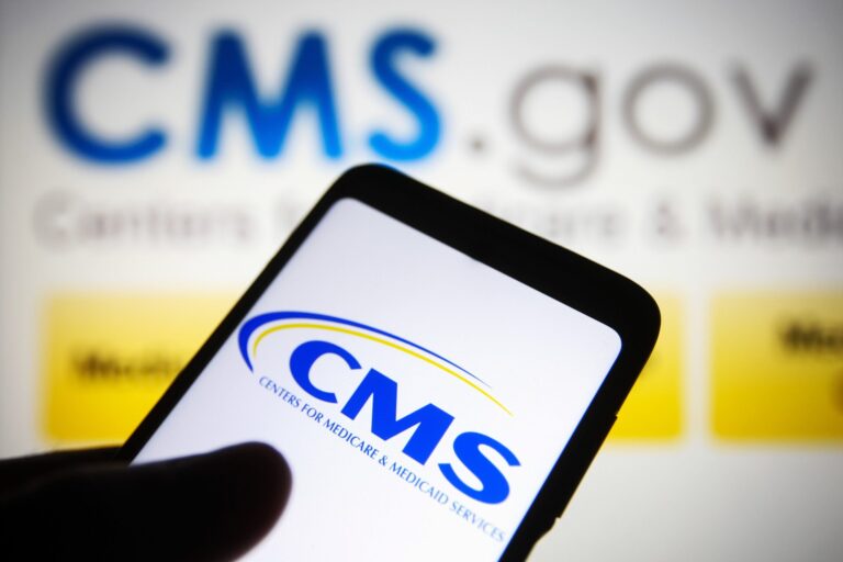 CMS logo displayed on smartphone with CMS.gov website in the background, highlighting Medicare compliance and settlement planning oversight.