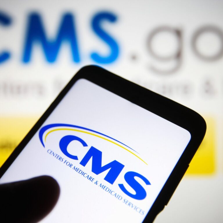 CMS logo displayed on smartphone with CMS.gov website in the background, highlighting Medicare compliance and settlement planning oversight.