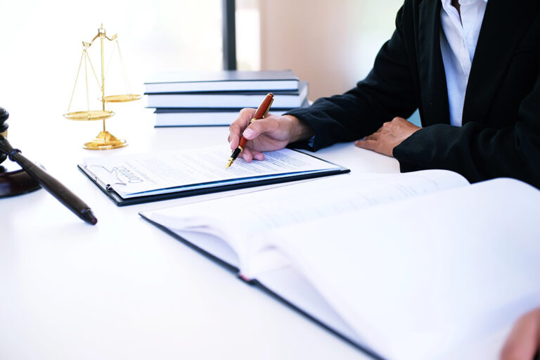 Female lawyer Legal counsel presents to the client a signed contract with gavel and legal law. justice and lawyer woman business concept
