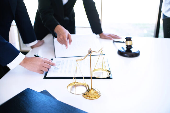 Female lawyer Legal counsel presents to the client a signed contract with gavel and legal law. justice and lawyer woman business concept