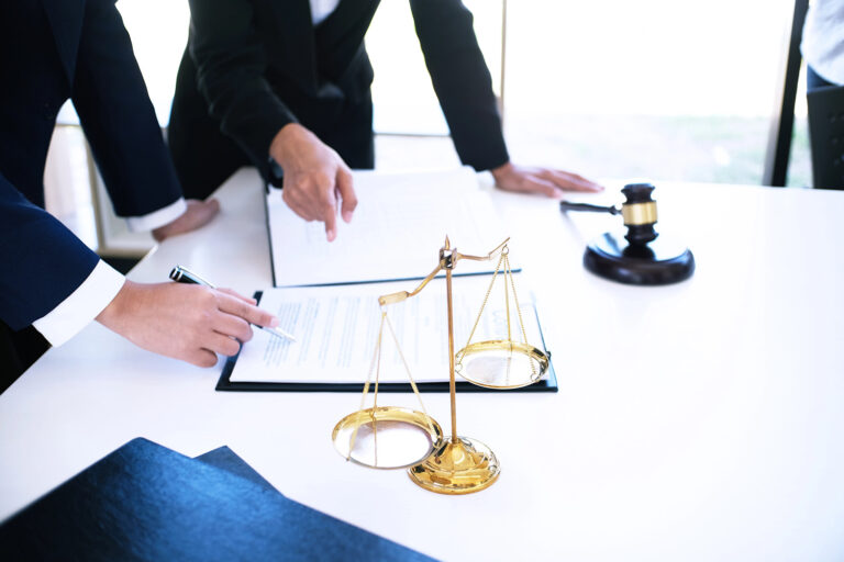 Female lawyer Legal counsel presents to the client a signed contract with gavel and legal law. justice and lawyer woman business concept