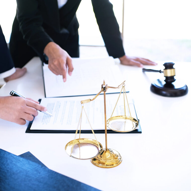 Female lawyer Legal counsel presents to the client a signed contract with gavel and legal law. justice and lawyer woman business concept