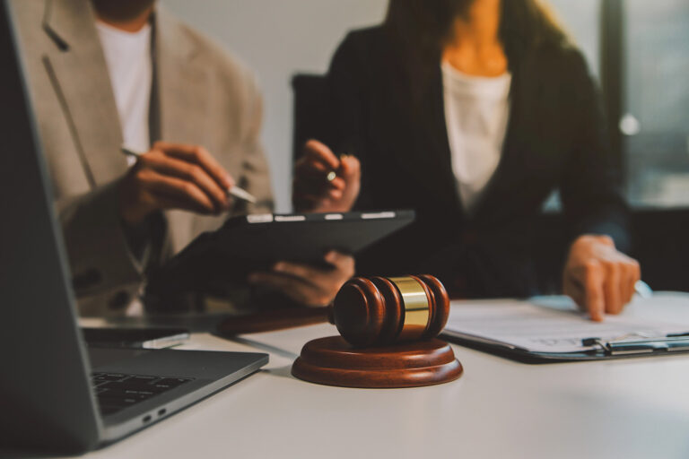 Lawyer, legal advisor, businessman brainstorming information on agreement details Business contracts in legal processing books for accuracy in contract documents. joint financial investment.