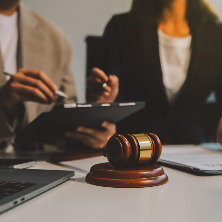 Lawyer, legal advisor, businessman brainstorming information on agreement details Business contracts in legal processing books for accuracy in contract documents. joint financial investment.