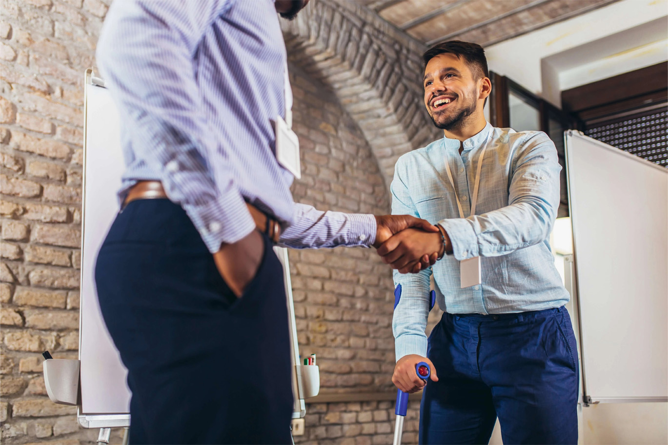 Disabled client and attorney shaking hands